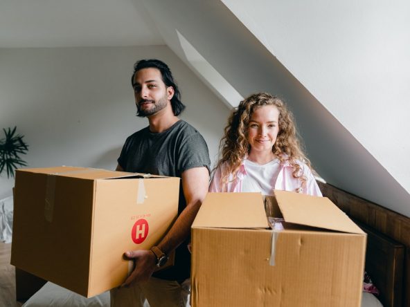 Man and woman holding boxes